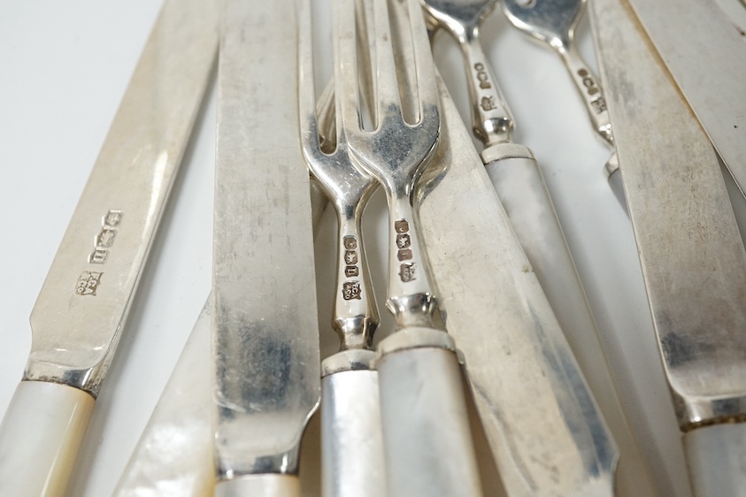 Eleven pairs of George V mother of pearl handled silver dessert eaters and one knife to match, Frederick C Asman & Co, Sheffield, 1930, knife 18.1cm. Condition - fair to good